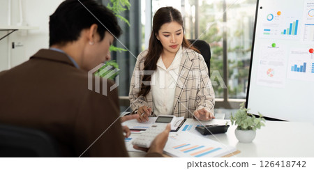 Collaborative Financial Planning. Professionals analyzing budget reports in a modern office. 126418742