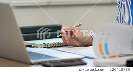Professional Writing. Close-up of a hand taking notes during a work session. 126418789