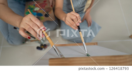 Activity mother and daughter painting close up of hands creating art 126418793