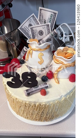 Celebratory Cake with Money Bags and Berries for a 38th Birthday Celebration Event Celebratory Cake with Money Bags and Berries for a 38th Birthday Celebration Event 126418960