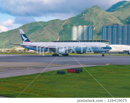 A Cathay Pacific Boeing 777 arrives at Hong Kong Chek Lap Kok Airport. A Cathay Pacific Boeing 777 arrives at Hong Kong Chek Lap Kok Airport. 126419075