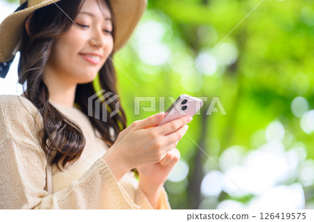 A neat woman operating a smartphone 126419575