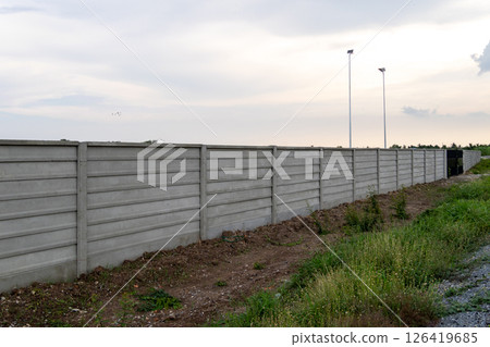 Concrete barrier installation in urban area landscape evening calm environment wide view Concrete barrier installation in urban area landscape evening calm environment wide view 126419685