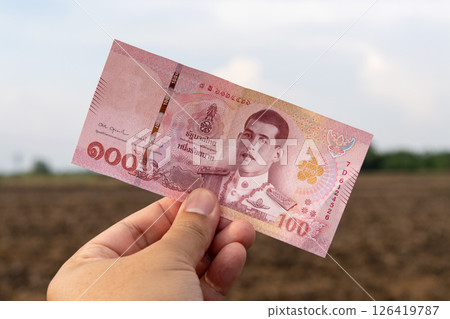 Currency in hand agricultural field money image outdoor close-up financial concept 126419787
