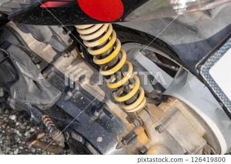 Mechanical workshop close-up motorcycle suspension system detailed engineering view Mechanical workshop close-up motorcycle suspension system detailed engineering view 126419800