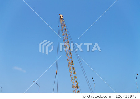 Industrial aerial view construction crane at building site under blue sky 126419973