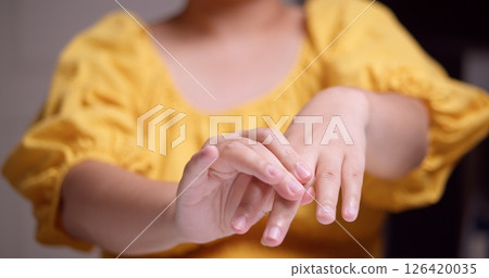 Child practicing hand movements indoor setting natural light close-up skill development 126420035