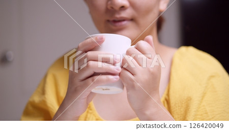 Enjoying a warm beverage cozy home lifestyle shot relaxing atmosphere close-up comfort Enjoying a warm beverage cozy home lifestyle shot relaxing atmosphere close-up comfort 126420049