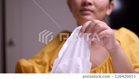 Woman disinfecting hands at home indoor setting health focus clean environment close-up view Woman disinfecting hands at home indoor setting health focus clean environment close-up view 126420053
