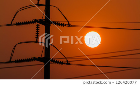 Sunset view over power lines energy infrastructure urban landscape evening horizon 126420077