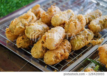 Crispy fried snacks street market food urban setting close-up culinary delight Crispy fried snacks street market food urban setting close-up culinary delight 126420093