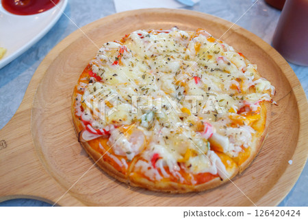 Delicious pizza topped with cheese and vegetables restaurant food indoor close-up culinary delight 126420424