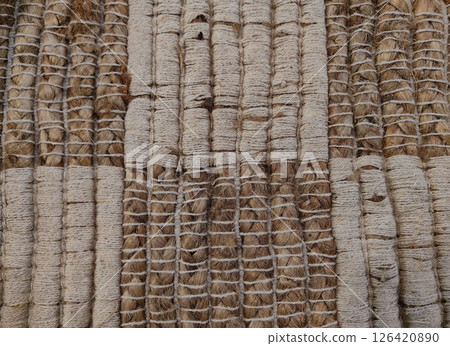 textured jute rug showcasing intricate weaving patterns in natural tones cozy home setting. closeup. textured jute rug showcasing intricate weaving patterns in natural tones cozy home setting. closeup. 126420890