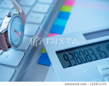 Documents, keyboard, watch and calculator on the table 126421135