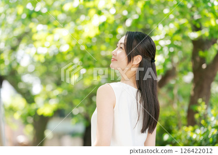 A woman relaxing in the park A woman relaxing in the park 126422012