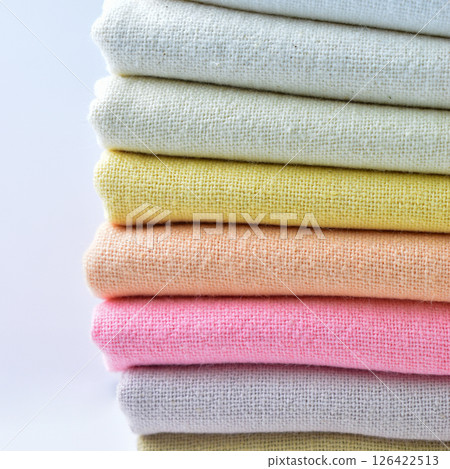 stack of colourful cotton clothes, close up pile of clothing 126422513