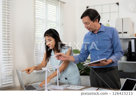 Sustainability in action: professionals collaborating on ESG solutions 126423213