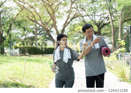 Wellness walking routine for seniors: couple enjoying walk in the park Wellness walking routine for seniors: couple enjoying walk in the park 126423280