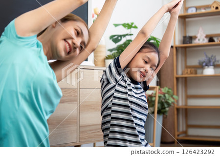 Wellness connection of mother and daughter stretching during yoga Wellness connection of mother and daughter stretching during yoga 126423292
