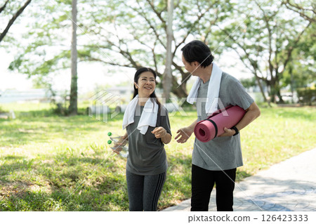 Wellness lifestyle illustrated by happy seniors couple walking outdoors Wellness lifestyle illustrated by happy seniors couple walking outdoors 126423333