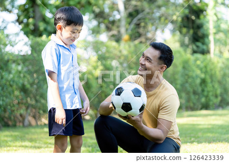 Wellness in family time: Father and son enjoying soccer play 126423339