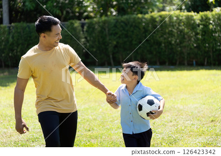 Activity: Father and Son Sharing a Soccer Moment in the Park 126423342