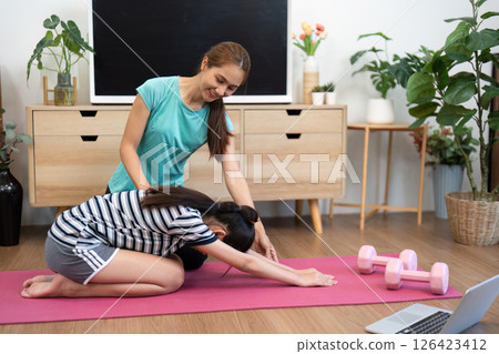 Mother and Daughter Wellness. Practicing Yoga Together at Home. Mother and Daughter Wellness. Practicing Yoga Together at Home. 126423412
