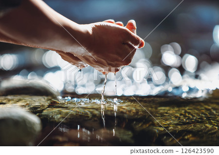Drink the clear and clean water of the clean stream in your hand, the precious water of life, World Water Day background Drink the clear and clean water of the clean stream in your hand, the precious water of life, World Water Day background 126423590