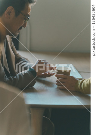 一名 50 多歲的男子在工作時吃藥 126423604