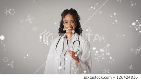 Image of molecules over smiling biracial female doctor 126424810