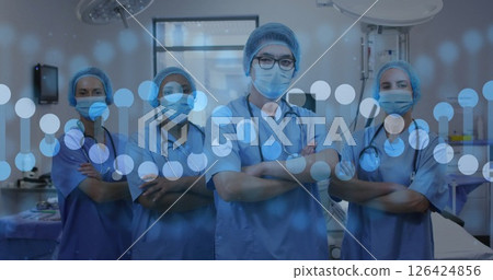 Image of dna strand over diverse doctors with face masks 126424856