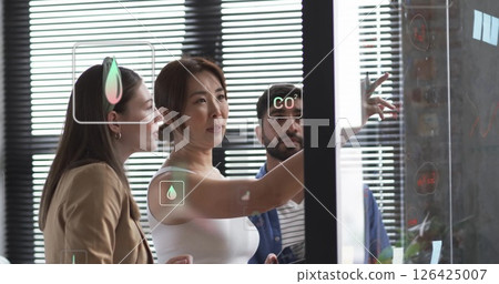 Image of ecology icons over diverse colleagues talking in office Image of ecology icons over diverse colleagues talking in office 126425007