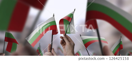 Bulgaria flags in their hands on a blurred urban background 126425158