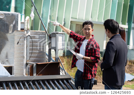 Sustainable Energy Solutions and Consultation. A technician explaining eco-friendly technologies during a site visit. Sustainable Energy Solutions and Consultation. A technician explaining eco-friendly technologies during a site visit. 126425693