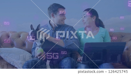 Image of 5g text repeated over happy caucasian couple with dog using laptop at home Image of 5g text repeated over happy caucasian couple with dog using laptop at home 126425745