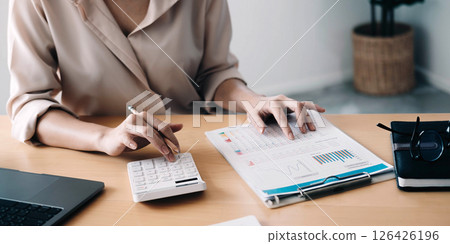 Close up view of bookkeeper or financial inspector hands making report, calculating or checking balance. Home finances, investment, economy, saving money or insurance concept 126426196