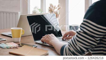 Close-up image of young professional male manager using laptop at he office, businessman working from home via portable computer Close-up image of young professional male manager using laptop at he office, businessman working from home via portable computer 126426218