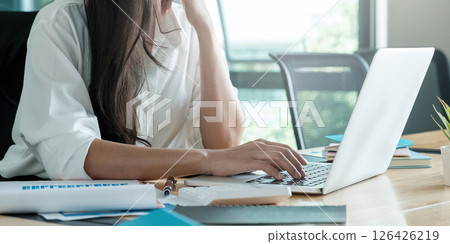 Close-up image of young professional female manager using laptop at her office, businesswoman working from home via portable computer 126426219
