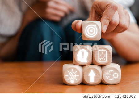 Wooden blocks with icons symbolizing strategic planning, innovation, and business growth. 126426308