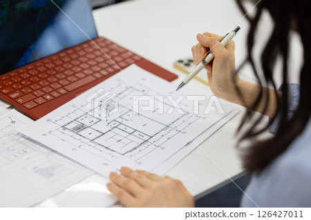 Architects checking architectural drawings 126427011
