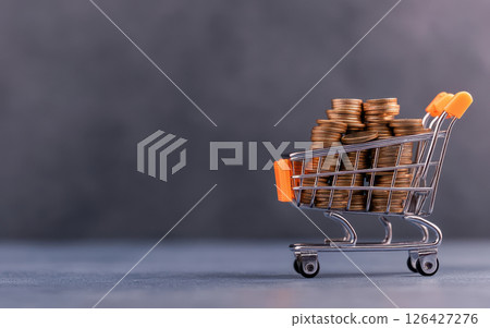creative sales growth concept featuring shopping cart filled with coins, symbolizing business success and commerce 126427276