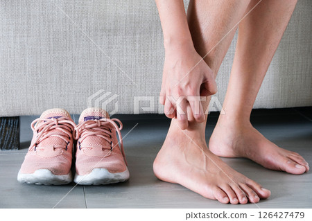 Men wear canvas shoes, he scratches legs and feet with itchy skin. Caused by of shoes Men wear canvas shoes, he scratches legs and feet with itchy skin. Caused by of shoes 126427479