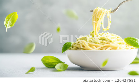 Delicious spaghetti with fresh basil leaves, creating vibrant and appetizing dish 126427681