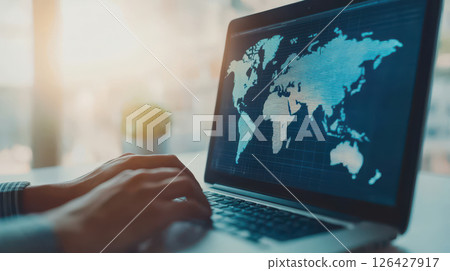 professional working on laptop with global map visualization, showcasing digital connectivity and data analysis 126427917