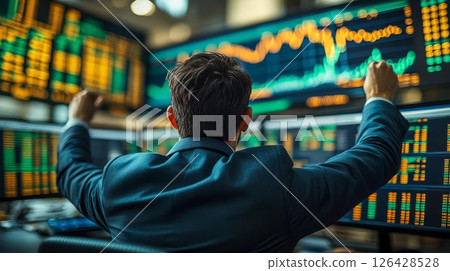A trader celebrating a stock market success with multiple screens displaying graphs. 126428528