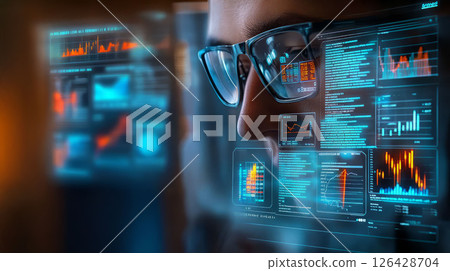 Focused individual analyzing data on a futuristic display with graphs and charts. 126428704