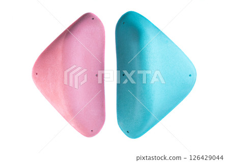 Two climbing holds with smooth rounded edges in blue and pink colors on white background. Identical shapes for hand or foot grip. Perfect for catalog or shop. Two climbing holds with smooth rounded edges in blue and pink colors on white background. Identical shapes for hand or foot grip. Perfect for catalog or shop. 126429044