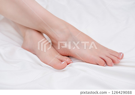 Close-up of beautiful woman's crossed legs Close-up of beautiful woman's crossed legs 126429088