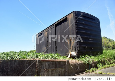 Summer scenery: blue sky and freight cars in a field Summer scenery: blue sky and freight cars in a field 126429112