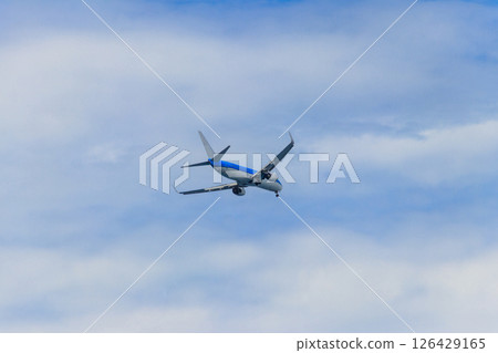 Passenger airplane flying in the blue sky 126429165